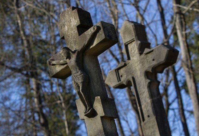 A close-up of a stone cross
Description automatically generated