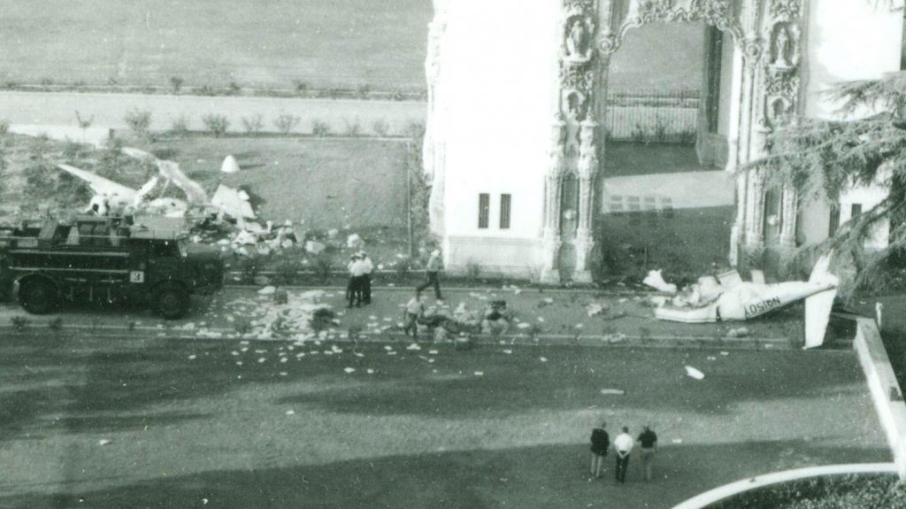 A group of people standing near a building Description automatically generated