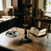 A vintage scale balancing a wooden cross on one side and an open old book on the other